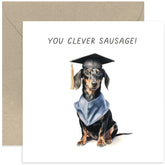 Old English Co. Cute Graduation Card For Him Or Her - 'Clever Sausage' Daschund Dog Graduation Cap Gown Card - Humorous Well Done Passed Exams Card For Son, Daughter, Sister, Brother, Grandchild