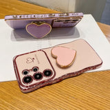 Luxury White Plating Love-Heart Kickstand Phone Case for Samsung Galaxy S26 Ultra, Curly Shape Raised Camera Shockproof TPU Protective Cover with Holder for Women Girls